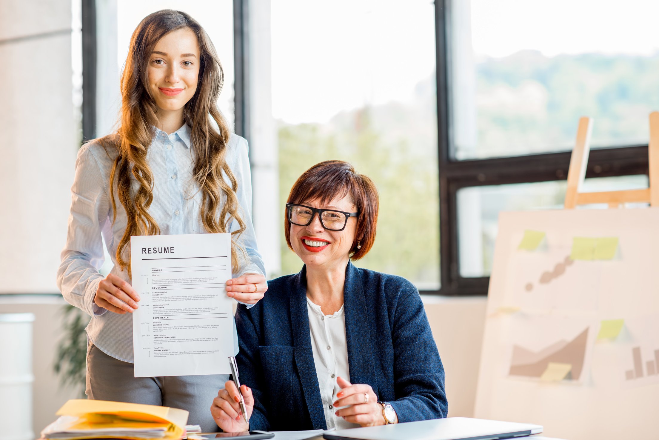 Young woman with resume at the office