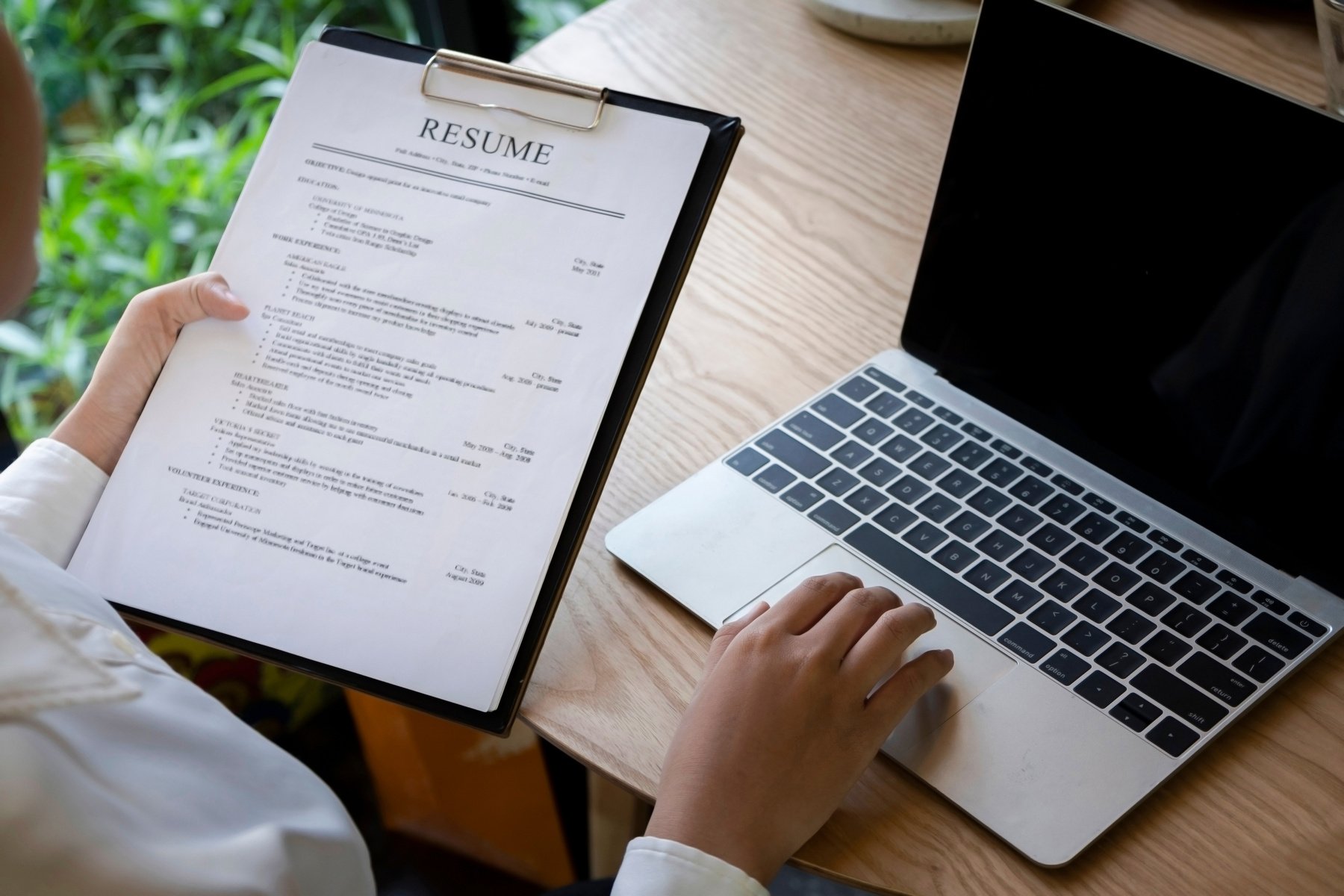 Business man review his resume application on desk, laptop computer, job seeker